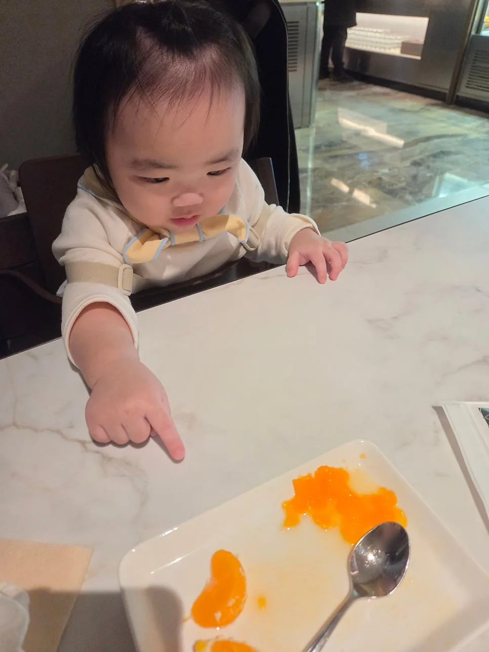 baby eating tangerine